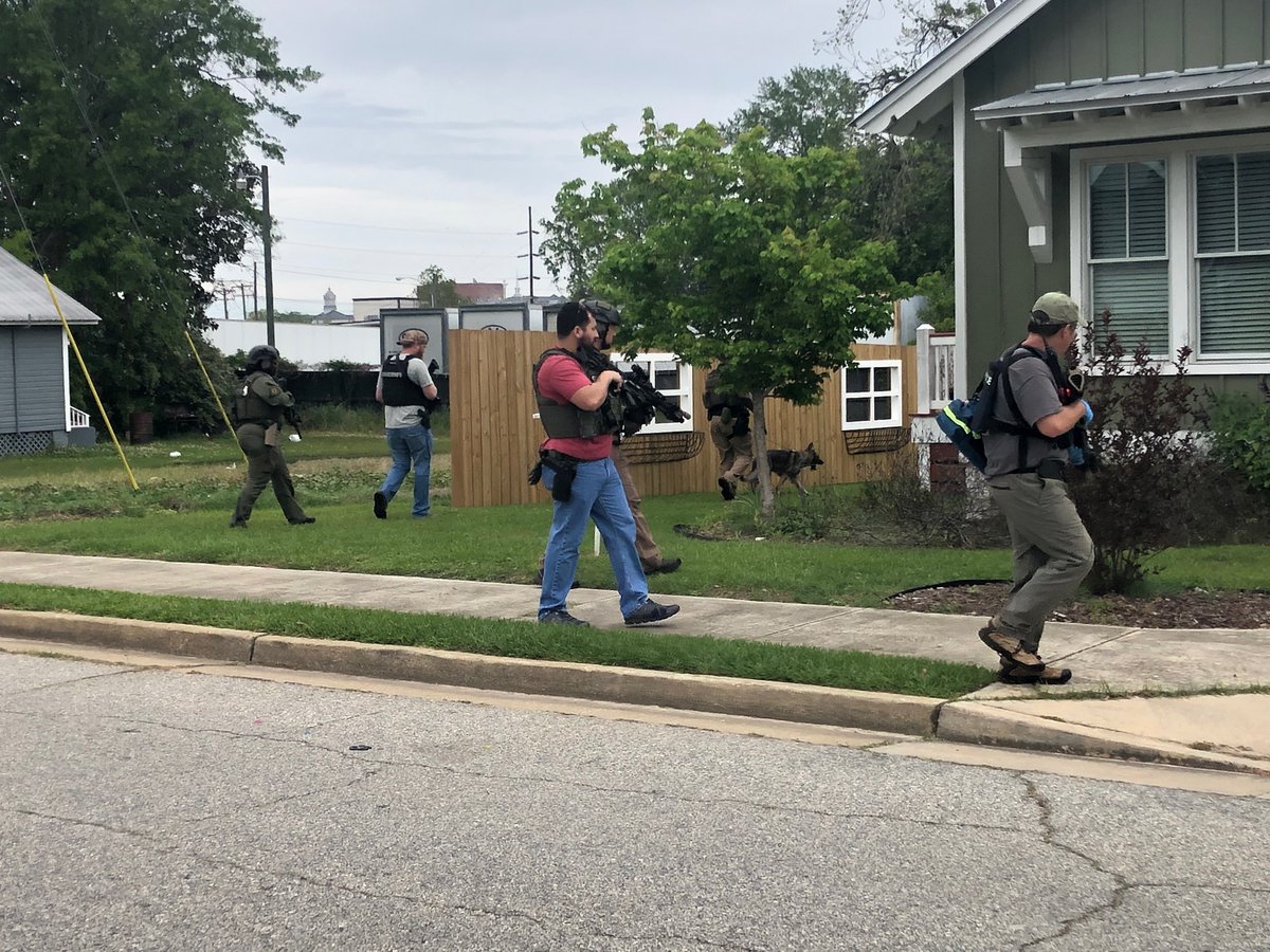 Plain clothes officers armed with rifles are searching this Thomasville neighborhood on the corner of Wright Street and Armster Lane for a man who shot at police earlier this morning   